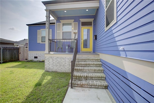 doorway to property featuring a yard and a porch