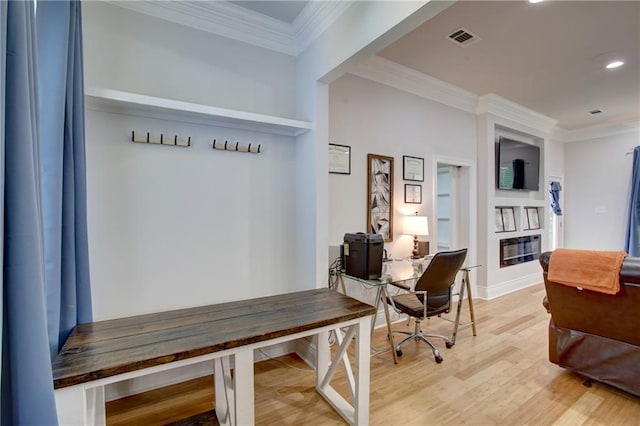 interior space with hardwood / wood-style flooring and crown molding