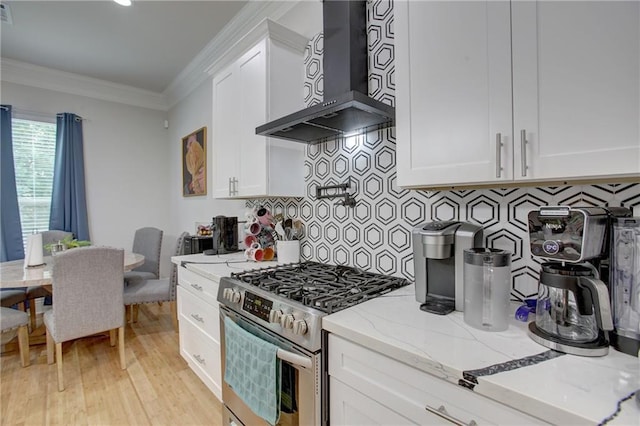 kitchen featuring white cabinetry, light stone countertops, wall chimney range hood, and high end range