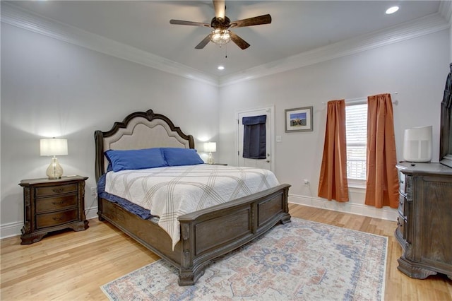 bedroom featuring ceiling fan, light hardwood / wood-style floors, and crown molding