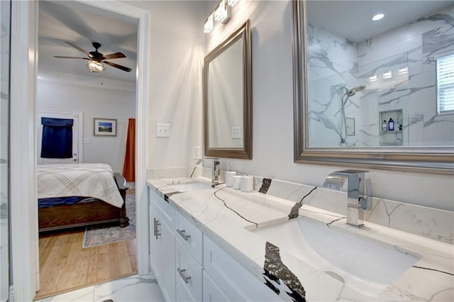 bathroom with a tile shower, vanity, hardwood / wood-style flooring, and ceiling fan