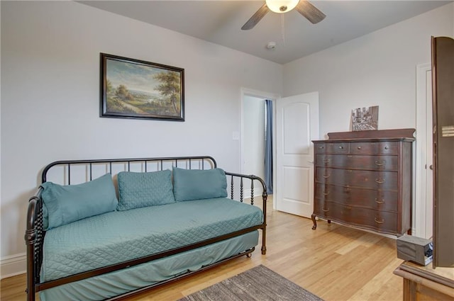 bedroom with ceiling fan and light hardwood / wood-style flooring