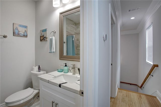 bathroom with a shower with curtain, vanity, toilet, and crown molding