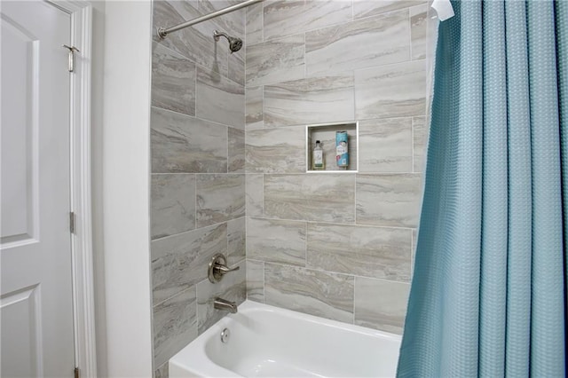 bathroom with shower / bath combo with shower curtain