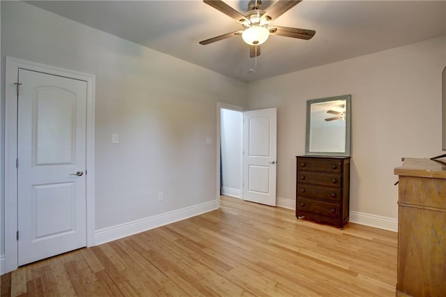 unfurnished bedroom with ceiling fan and light wood-type flooring