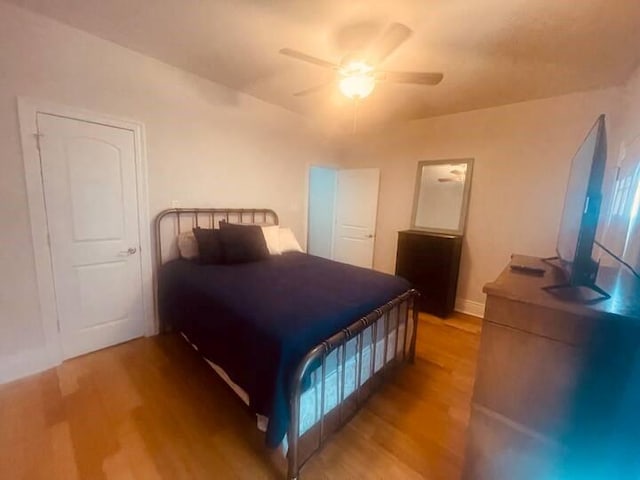 bedroom with ceiling fan and light hardwood / wood-style flooring