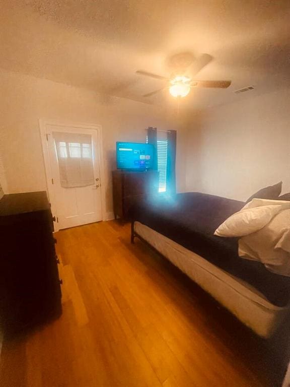 bedroom featuring hardwood / wood-style flooring and ceiling fan