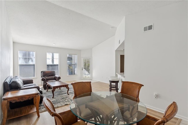 interior space with light hardwood / wood-style flooring and vaulted ceiling