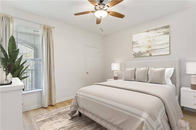 bedroom with light hardwood / wood-style flooring and ceiling fan