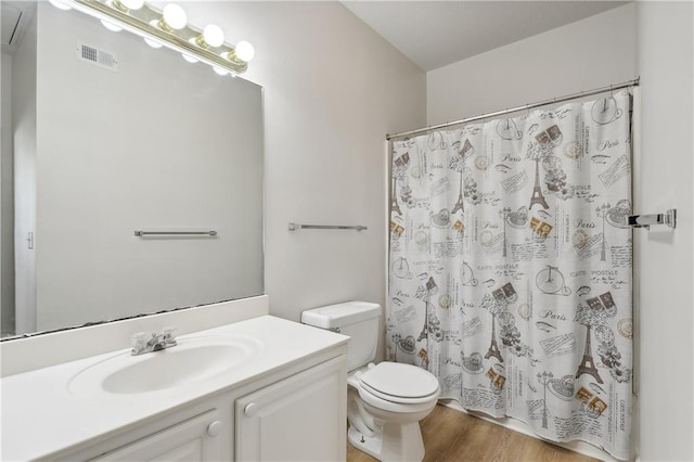 bathroom with wood-type flooring, vanity, toilet, and a shower with curtain