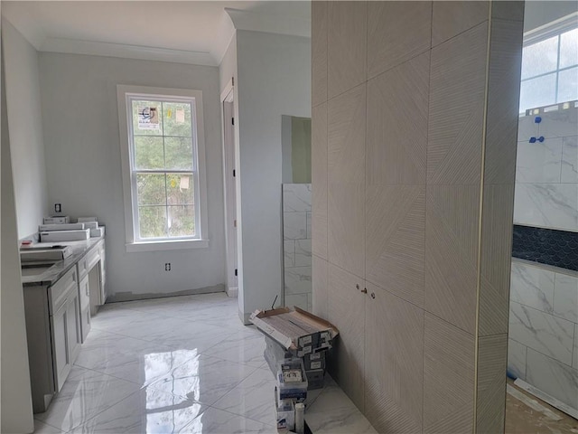 bathroom with vanity, tile walls, and ornamental molding