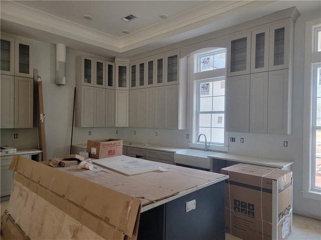 kitchen featuring white cabinetry, a kitchen island, plenty of natural light, and sink