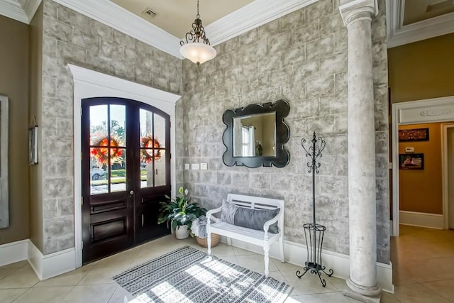 tiled entryway with decorative columns, ornamental molding, and french doors