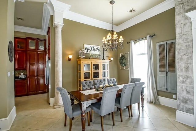 tiled dining area with a chandelier, crown molding, and decorative columns