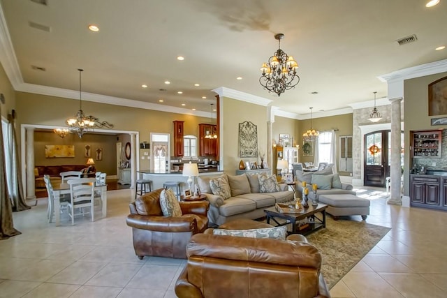 living room with decorative columns, crown molding, and light tile patterned floors