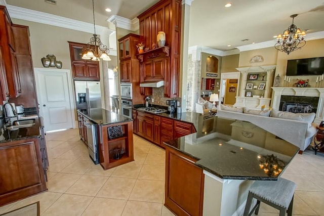 kitchen with ornamental molding, stainless steel appliances, sink, hanging light fixtures, and light tile patterned flooring