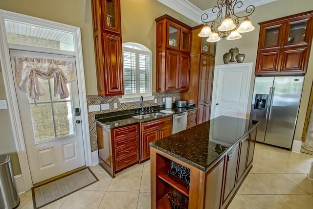 kitchen featuring hanging light fixtures, tasteful backsplash, crown molding, a kitchen island, and appliances with stainless steel finishes