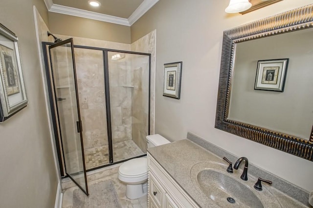 bathroom featuring vanity, toilet, a shower with shower door, and crown molding