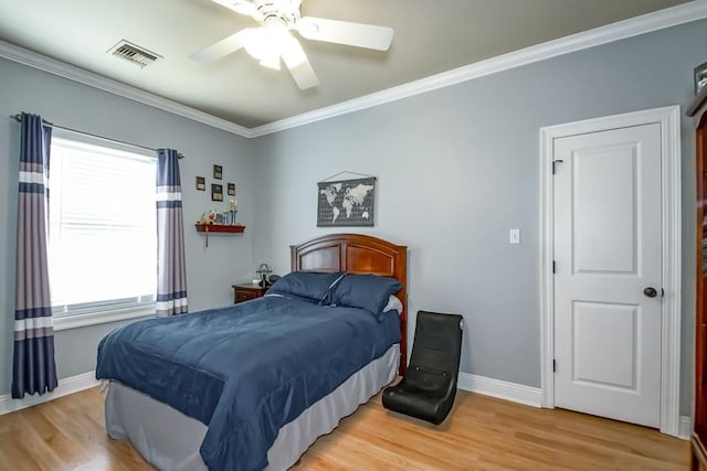 bedroom with ceiling fan, wood-type flooring, crown molding, and multiple windows