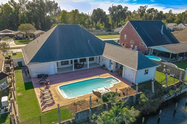 view of swimming pool with a water view and a patio area