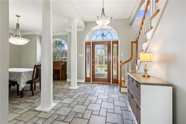 foyer entrance featuring ornate columns and crown molding