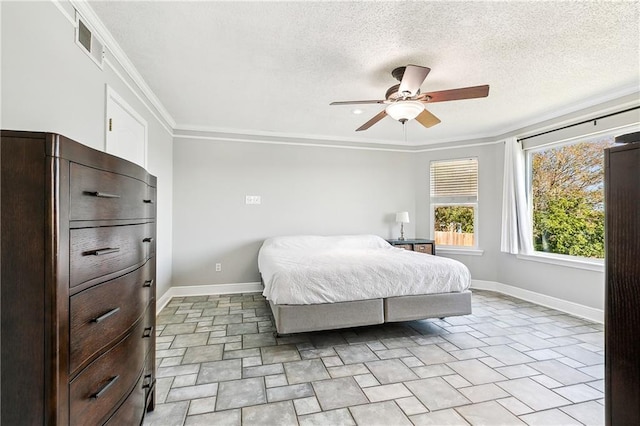 bedroom featuring ceiling fan, crown molding, and a textured ceiling