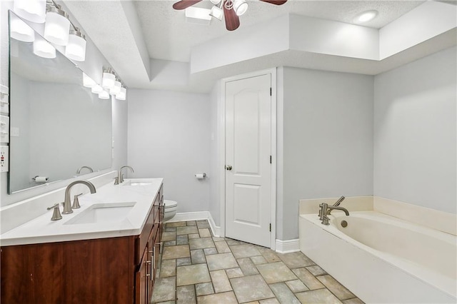 bathroom with a washtub, vanity, toilet, and ceiling fan