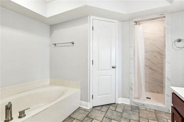 bathroom with vanity and shower with separate bathtub