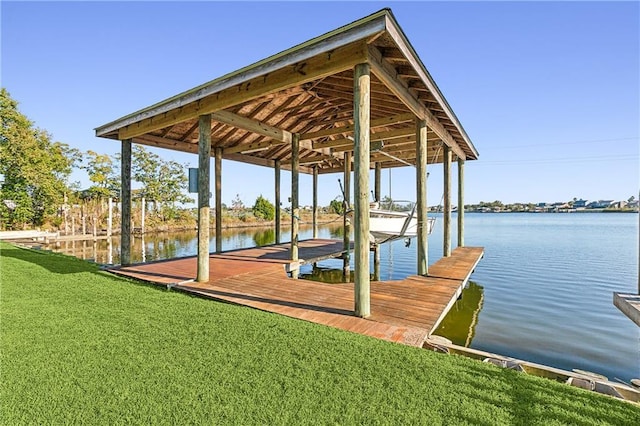 dock area with a yard and a water view