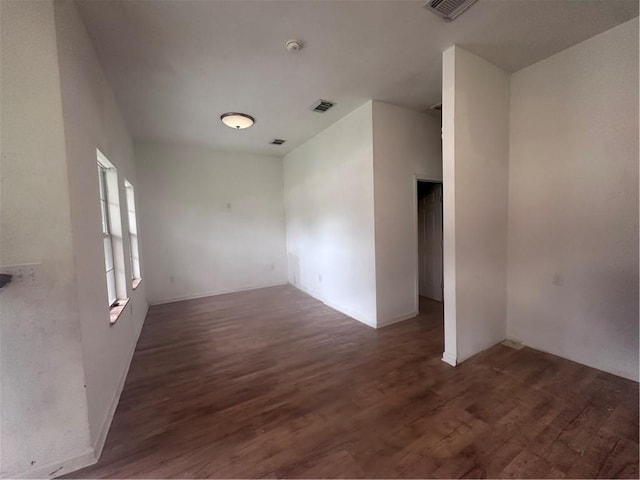 spare room with dark hardwood / wood-style floors