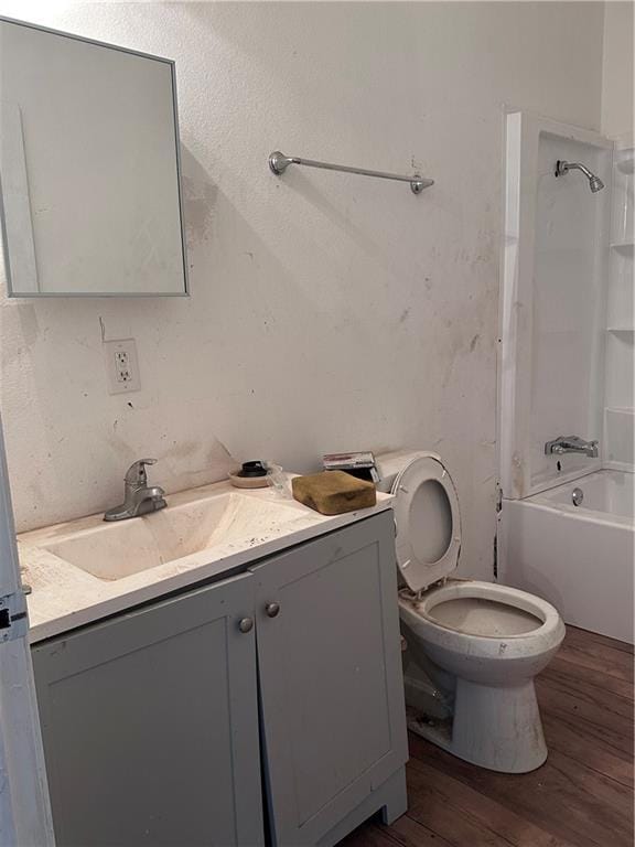 full bathroom featuring vanity, toilet, wood-type flooring, and bathing tub / shower combination