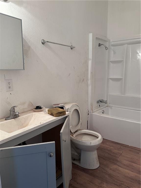 full bathroom with hardwood / wood-style floors, vanity, bathtub / shower combination, and toilet