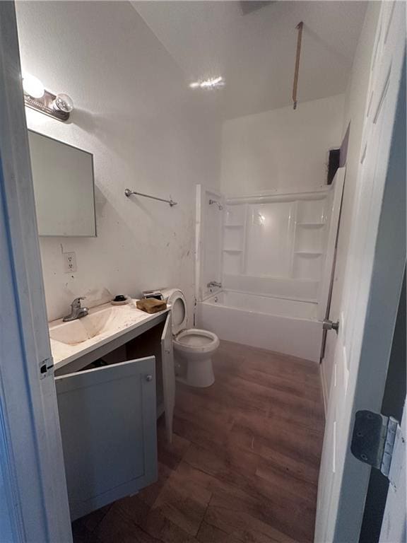 full bathroom featuring shower / bathing tub combination, vanity, hardwood / wood-style flooring, and toilet