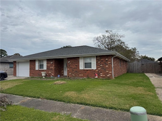 ranch-style house featuring a front lawn and a garage