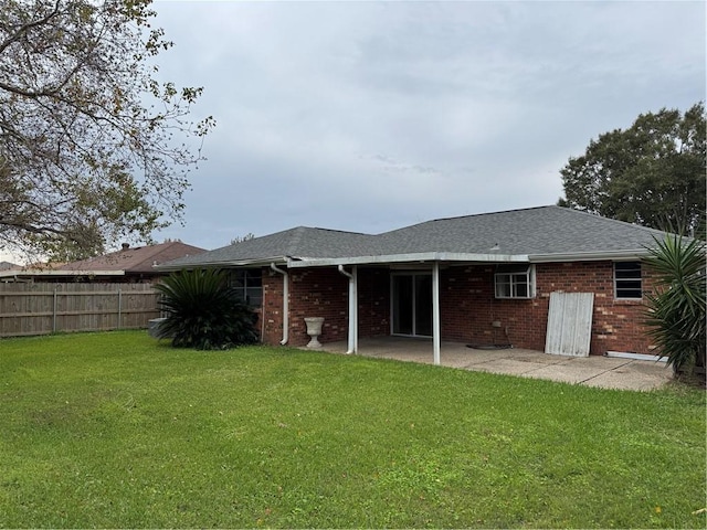 back of property with a patio area and a yard