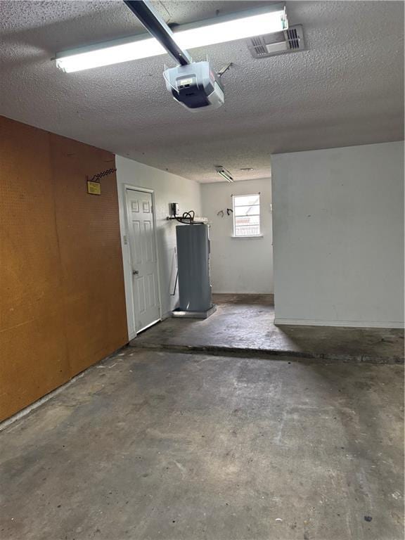 garage featuring water heater and a garage door opener