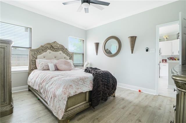 bedroom featuring multiple windows, ceiling fan, ornamental molding, and light wood-type flooring