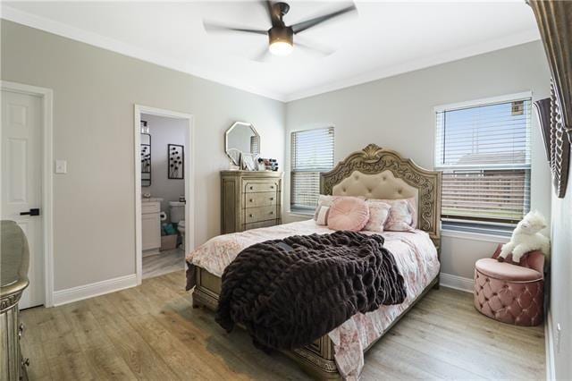 bedroom with light wood-type flooring, connected bathroom, ceiling fan, and ornamental molding