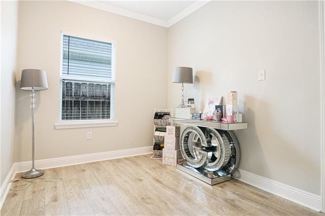 laundry room with light hardwood / wood-style flooring and ornamental molding