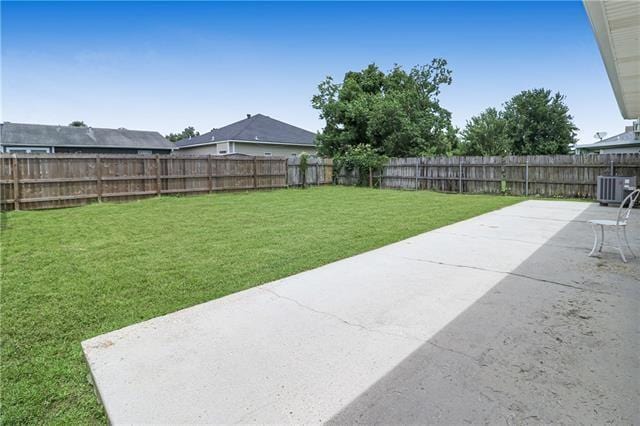 view of yard with cooling unit and a patio area