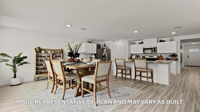 dining area featuring light wood-type flooring