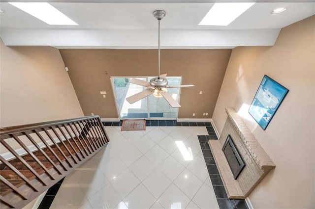 living room with ceiling fan and tile patterned floors