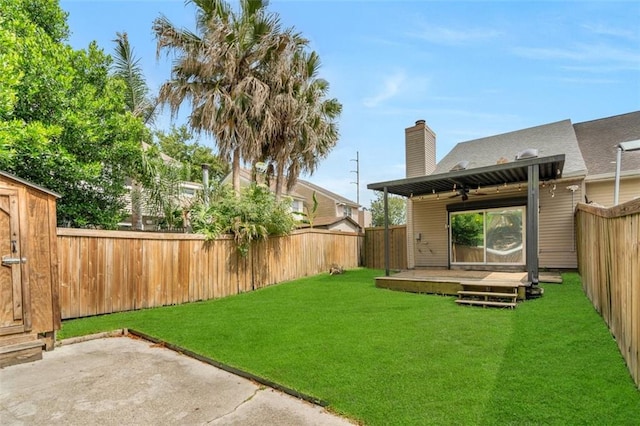 view of yard with a patio, ceiling fan, and a deck