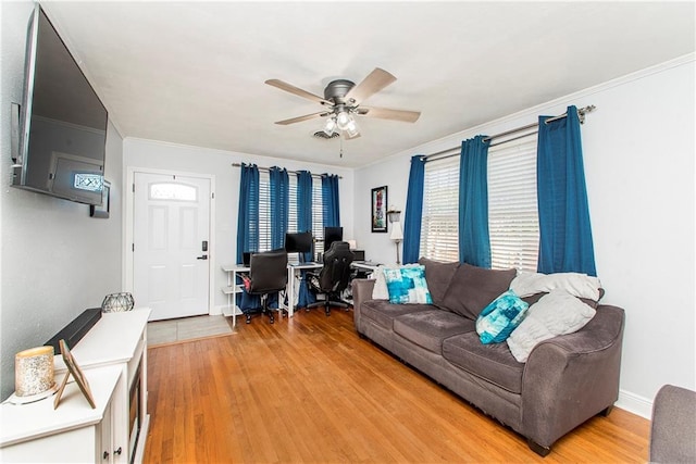 living room featuring hardwood / wood-style flooring, ceiling fan, and ornamental molding