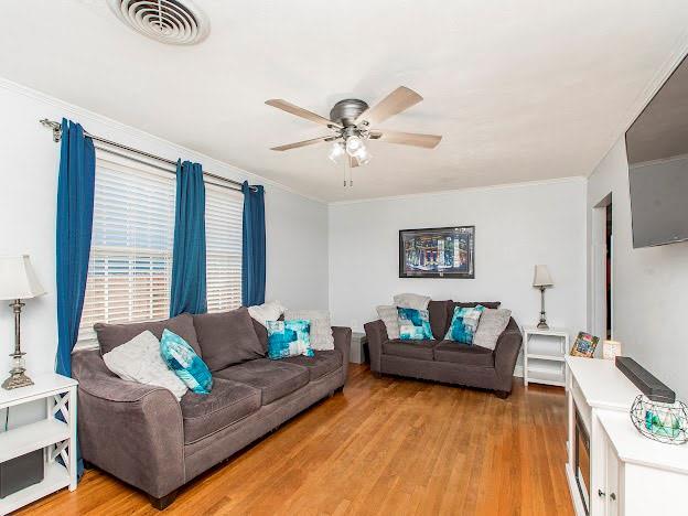 living room with ceiling fan and wood-type flooring