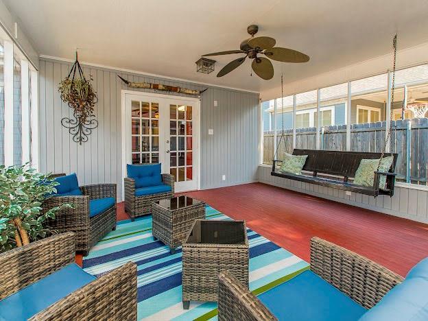 sunroom with french doors, ceiling fan, and a wealth of natural light