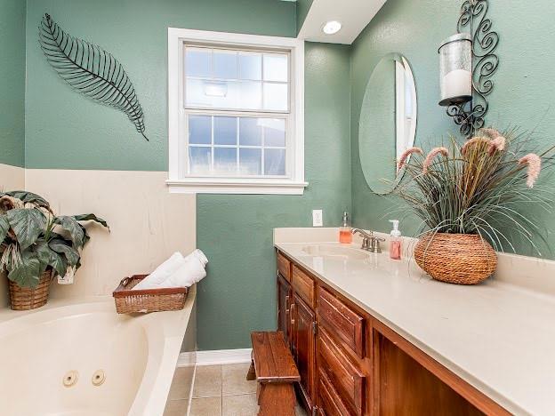 bathroom with vanity, a bathtub, and tile patterned floors