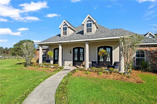 view of front of house featuring a front lawn and french doors