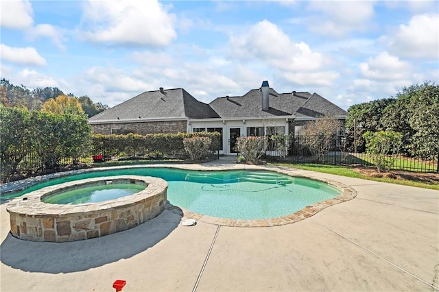 view of swimming pool with an in ground hot tub and a patio area