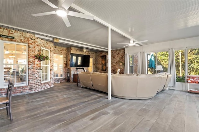 unfurnished sunroom featuring ceiling fan and lofted ceiling